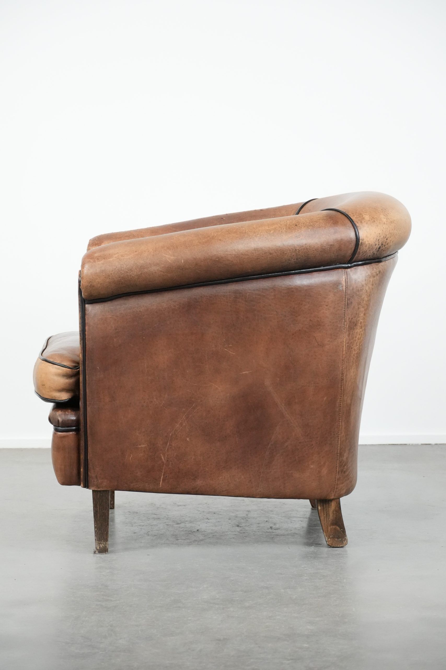 Sturdy vintage sheepskin club armchair with a beautiful patina
