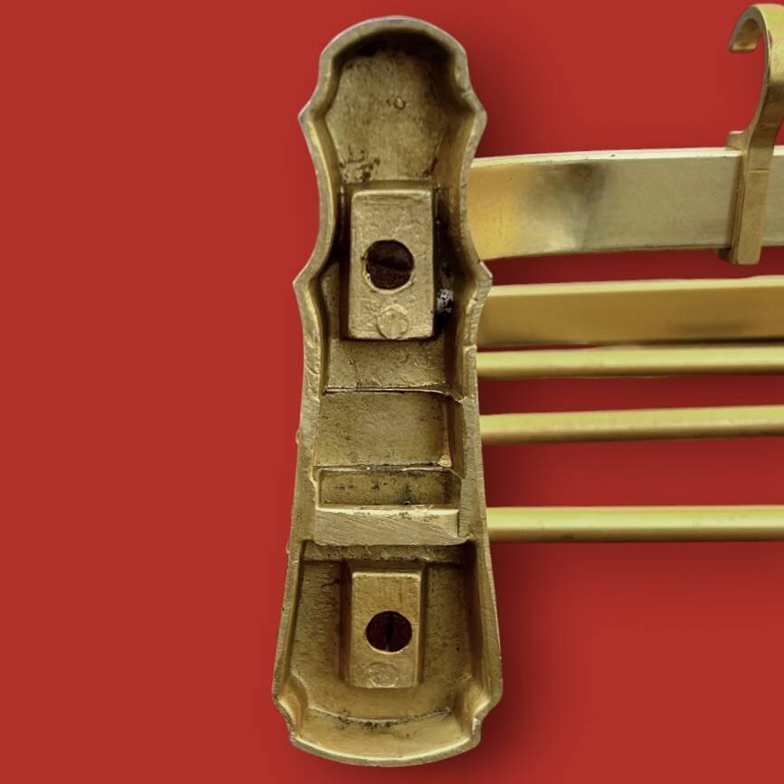 Vintage wall-mounted coat rack in anodised gold aluminium with hat holder.