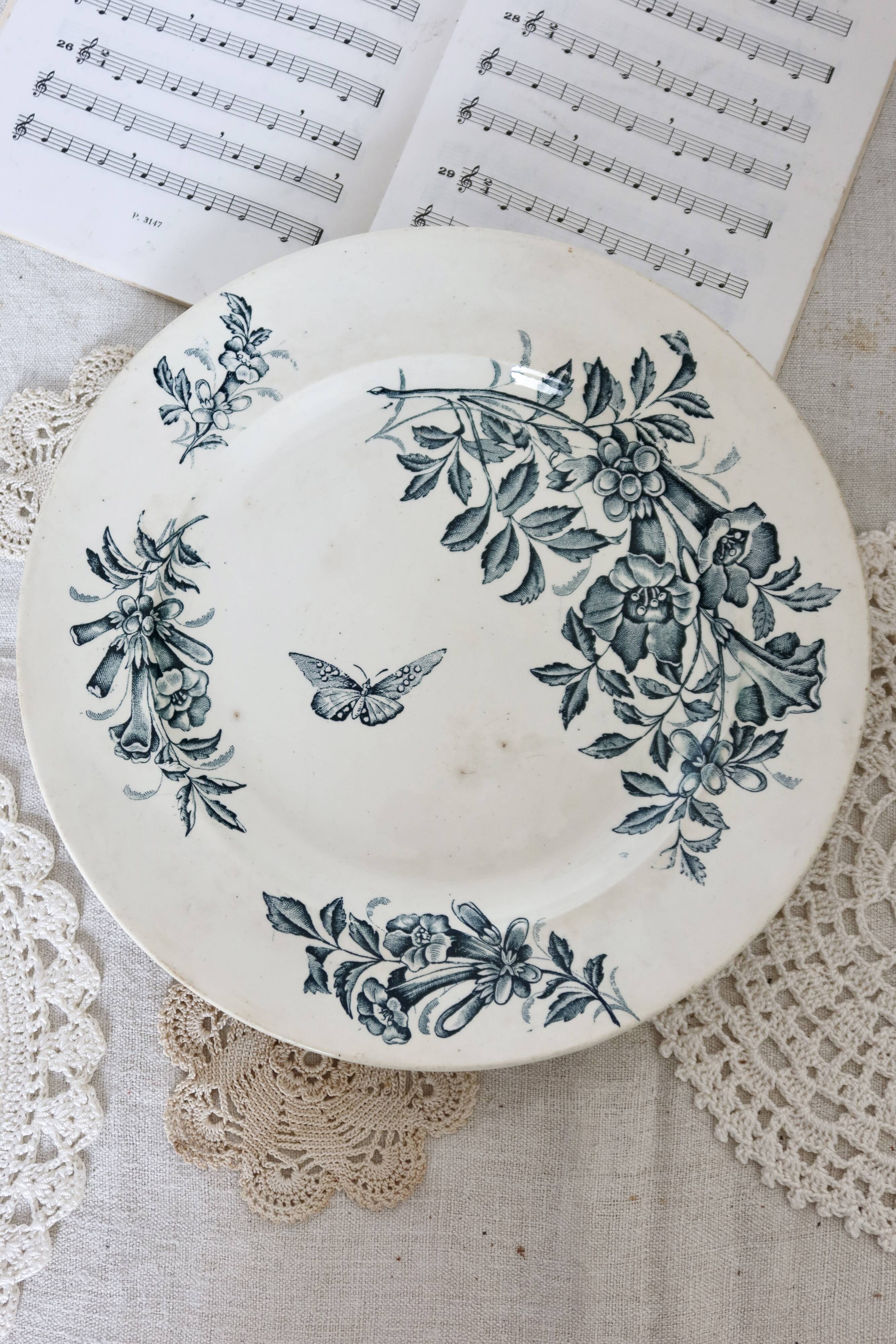 Plat de service rond terre de fer Badonviller modèle Jasmin motif fleuri papillon fin XIXème