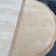 Extendable round table in renovated Louis XVI style, made of light wood, with 2 extensions.