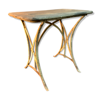 Ancient wrought iron and wood garden table