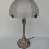 Art Nouveau style lamp, in bronze and frosted glass.