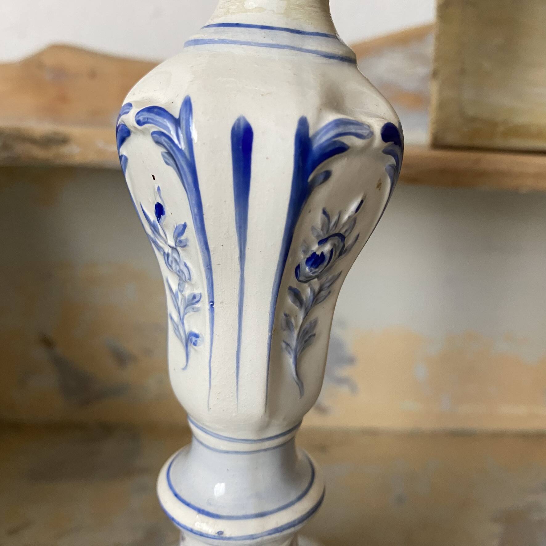 Antique Gien candlestick with ribbon and garland decoration.