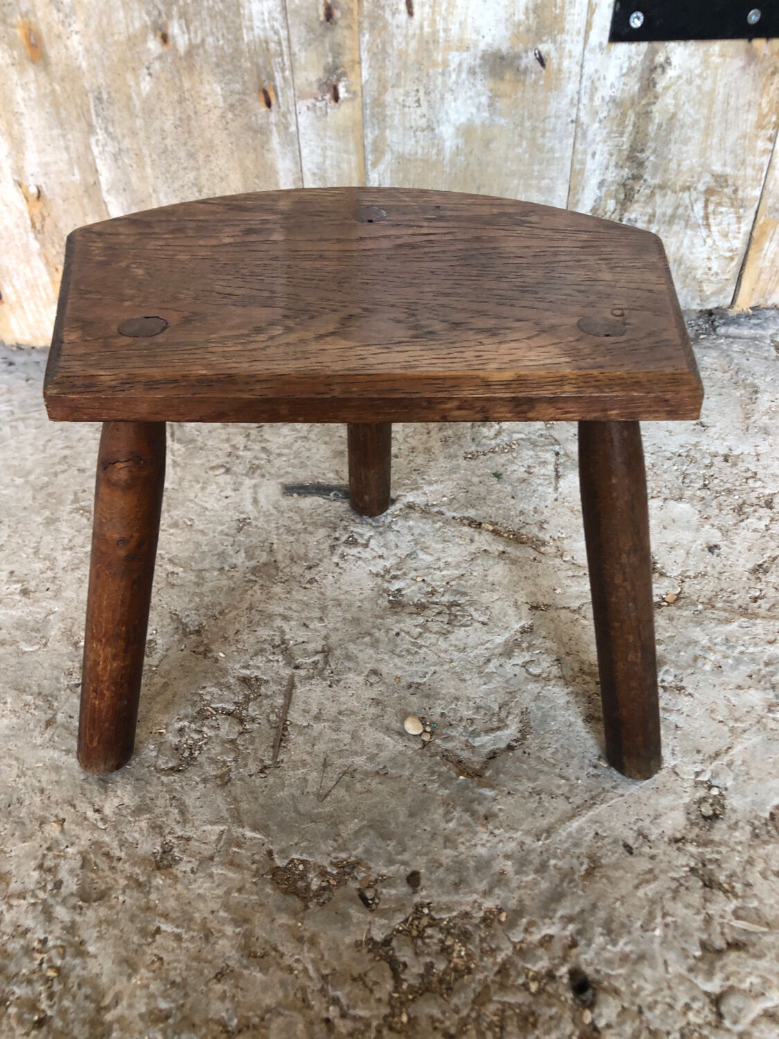 Old vintage wooden tripod milking stool