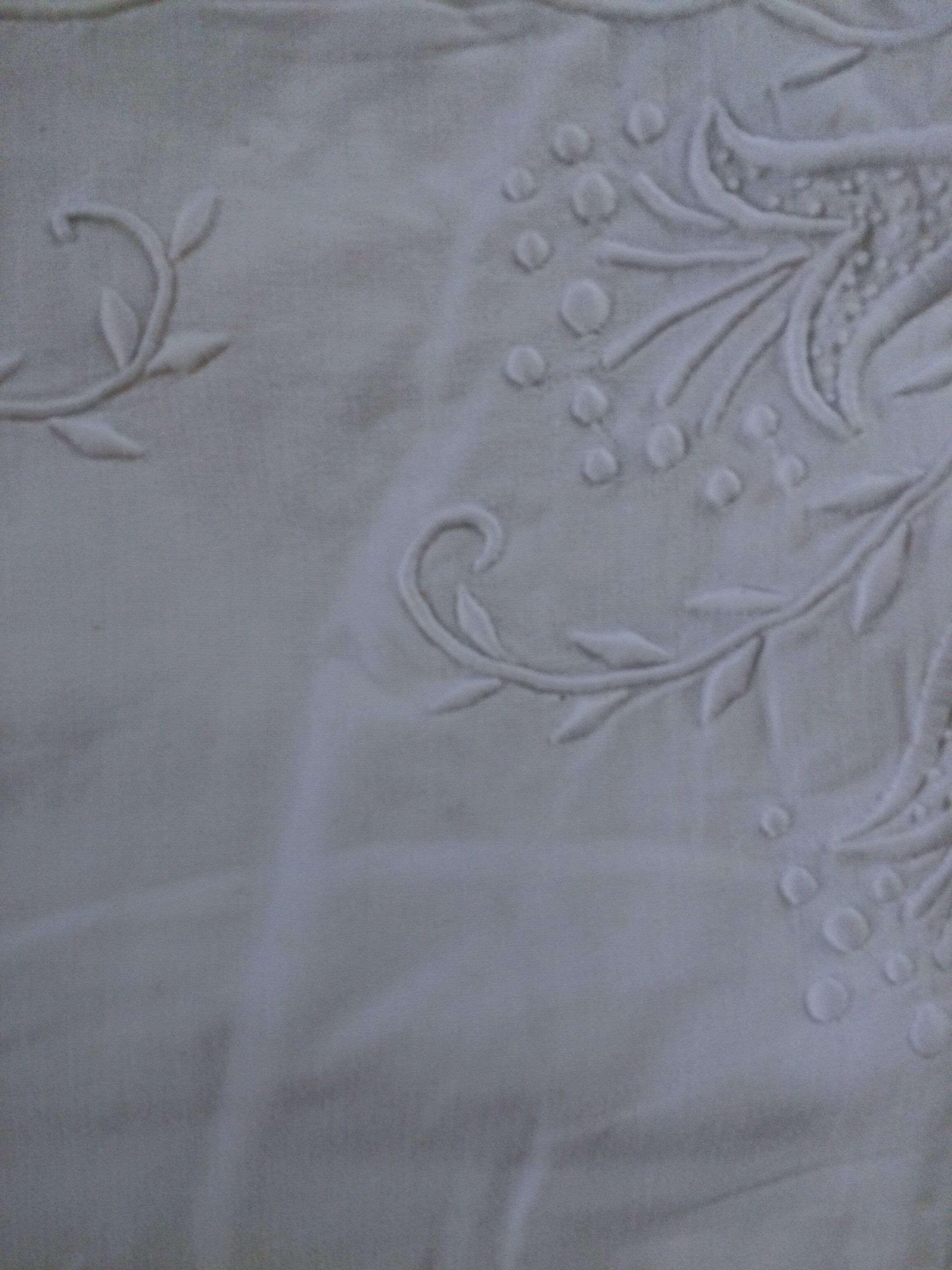 Old sheet with hand made embroidery, shaped flowers.