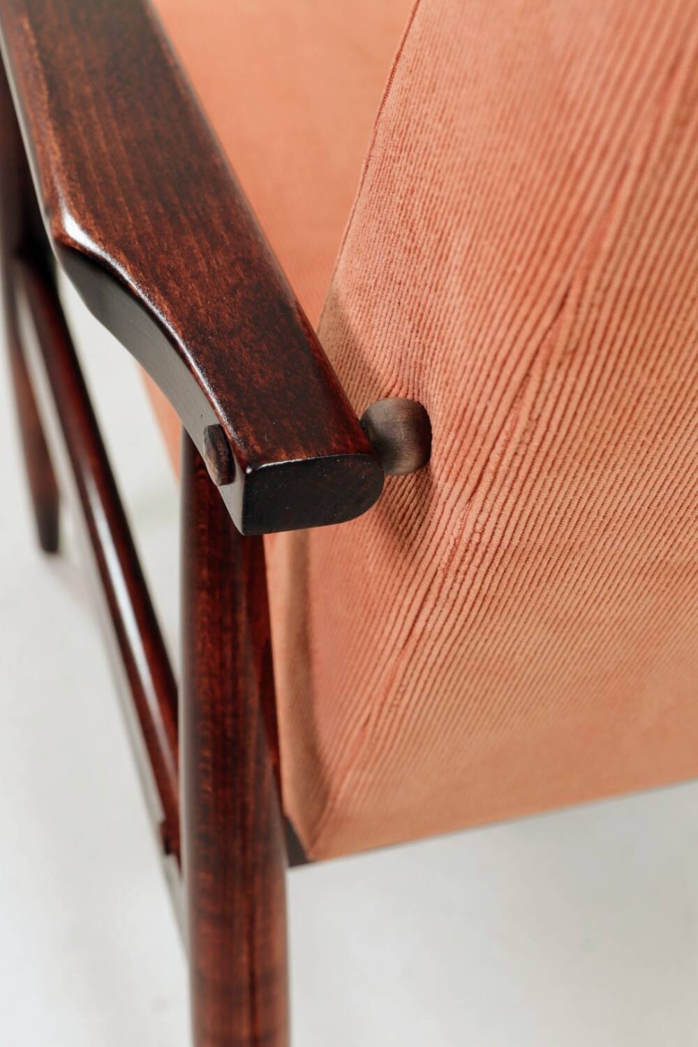 Mid-century modern armchair in coral red designed by H. Lis.