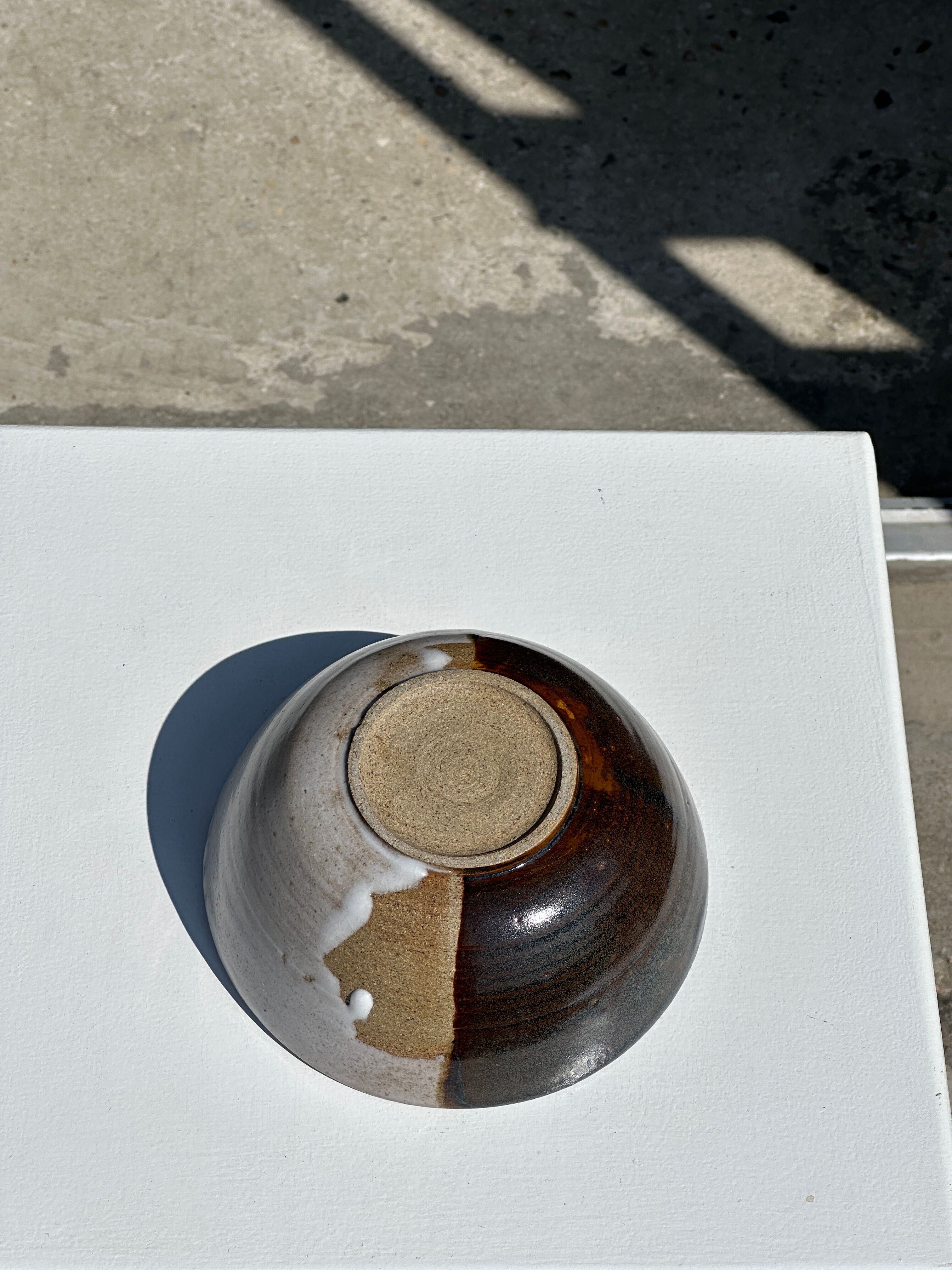 White and glossy brown two-tone ceramic bowl, matt earth