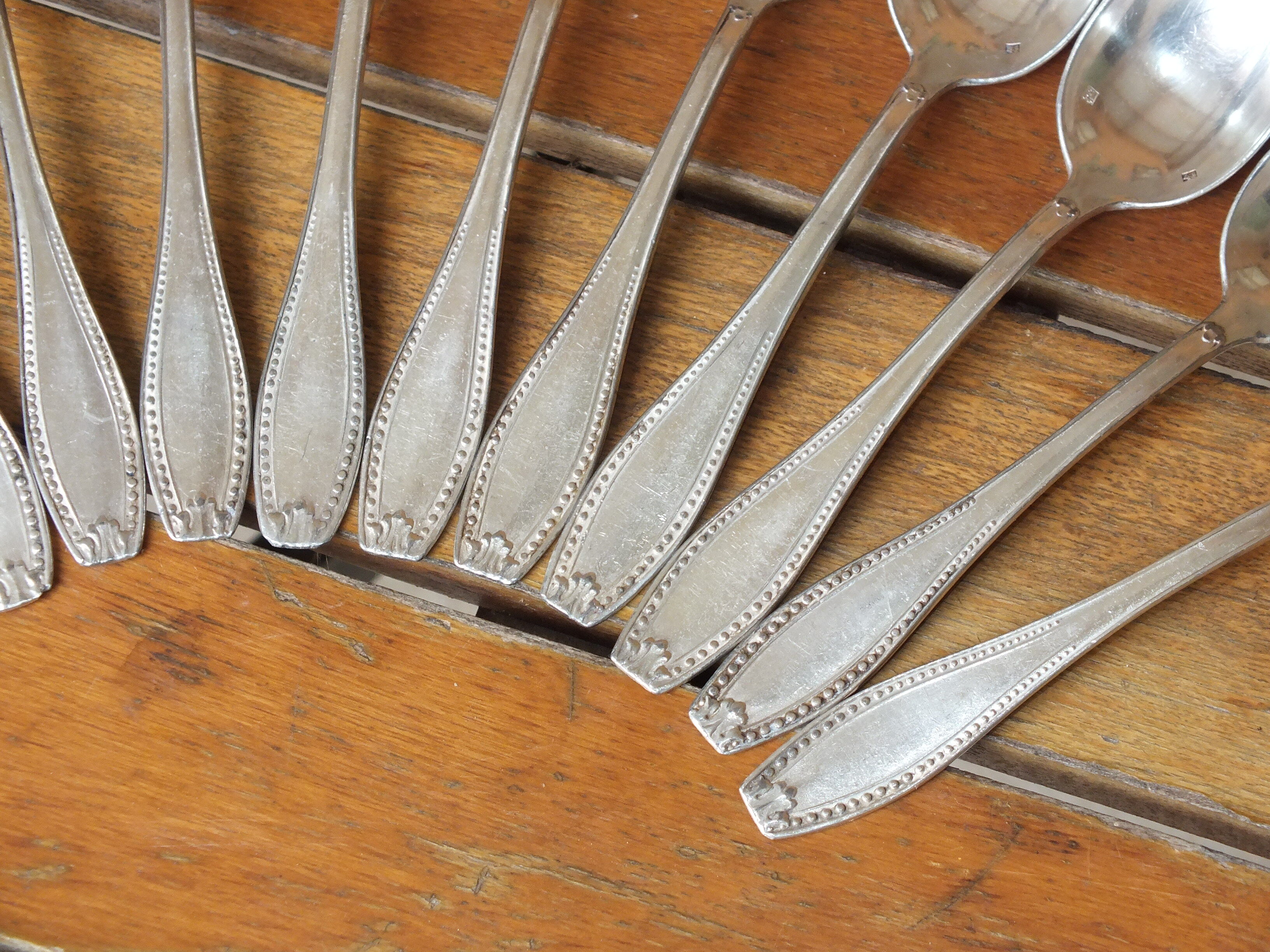 15 small silver metal spoons with rows of beads