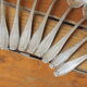 15 small silver metal spoons with rows of beads