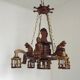 French vintage Breton chandelier with hand-carved figures, well, and lantern lights.