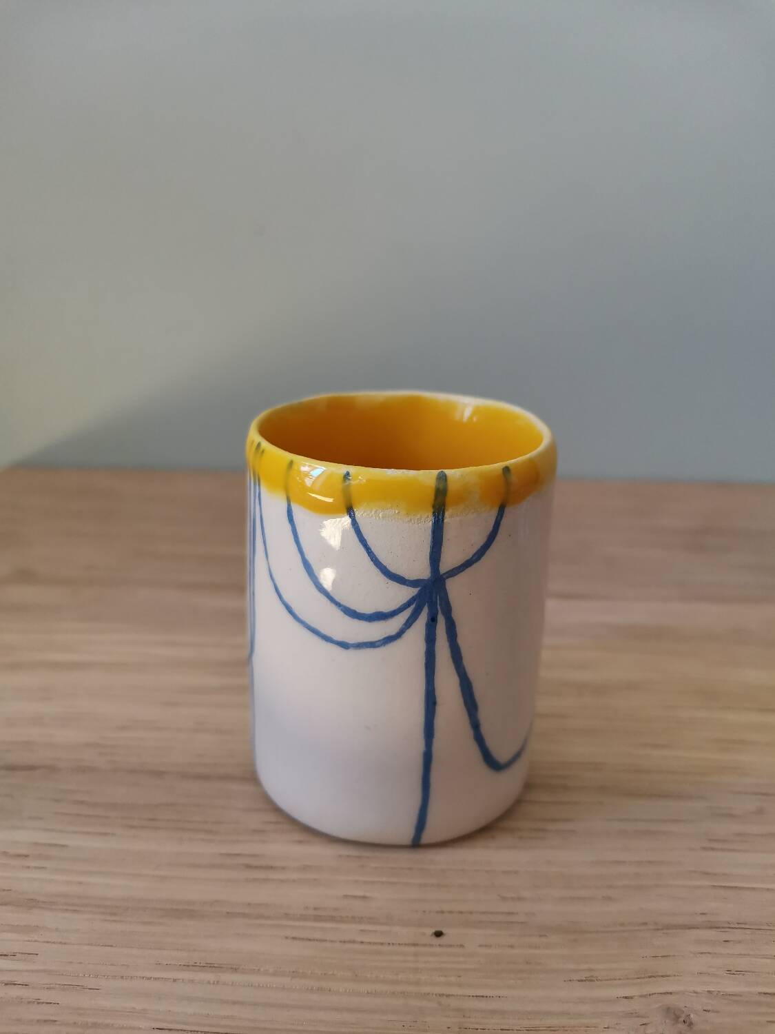 Handmade ceramic coffee cup blue yellow line