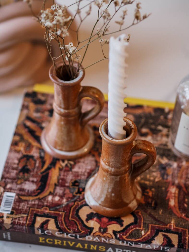 Set of two terracotta candle holders.