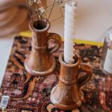 Set of two terracotta candle holders.