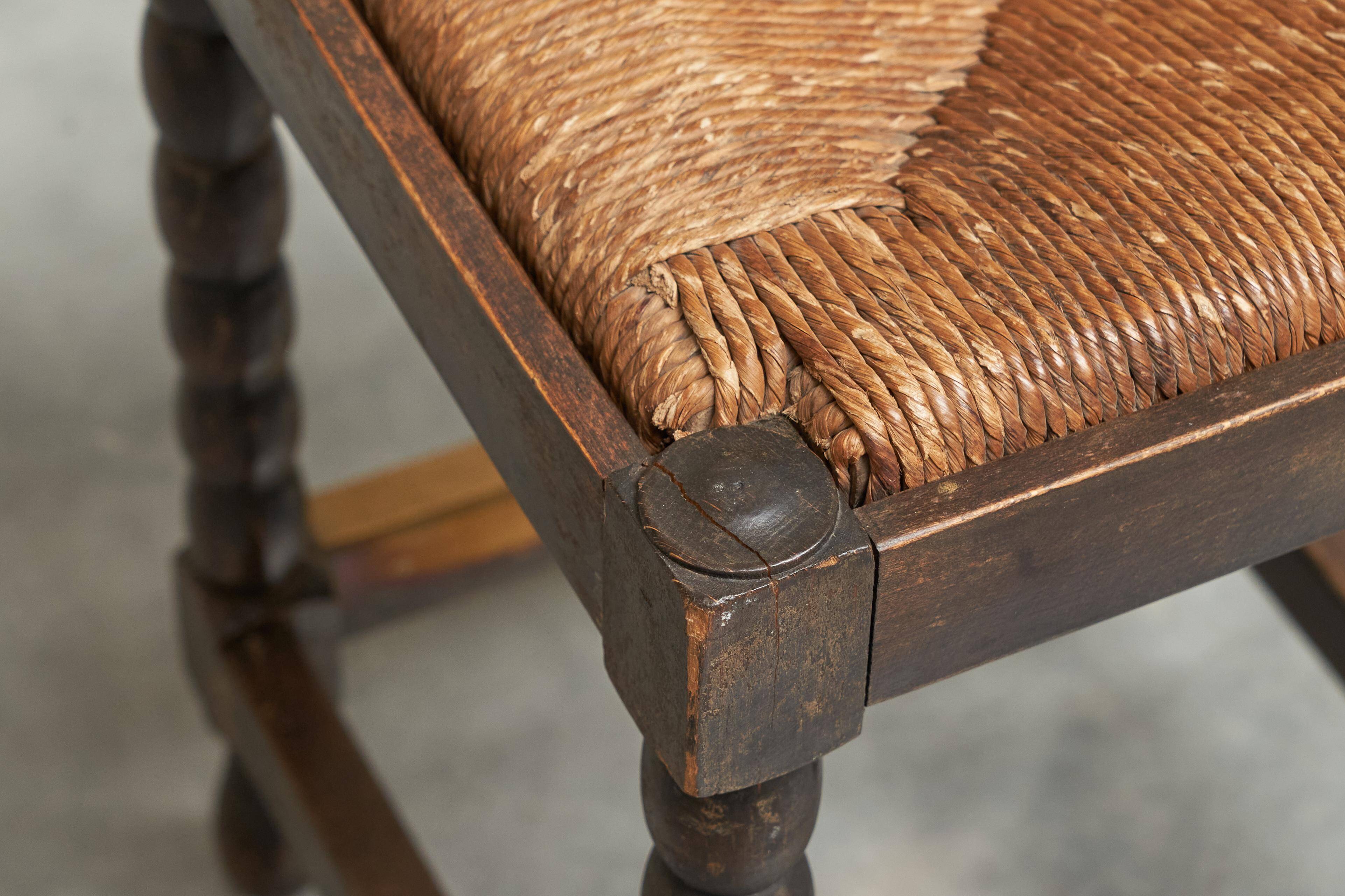 Solid oak stool, straw and brass from the 1920s.