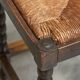 Solid oak stool, straw and brass from the 1920s.
