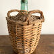 Demijohn surrounded by wicker