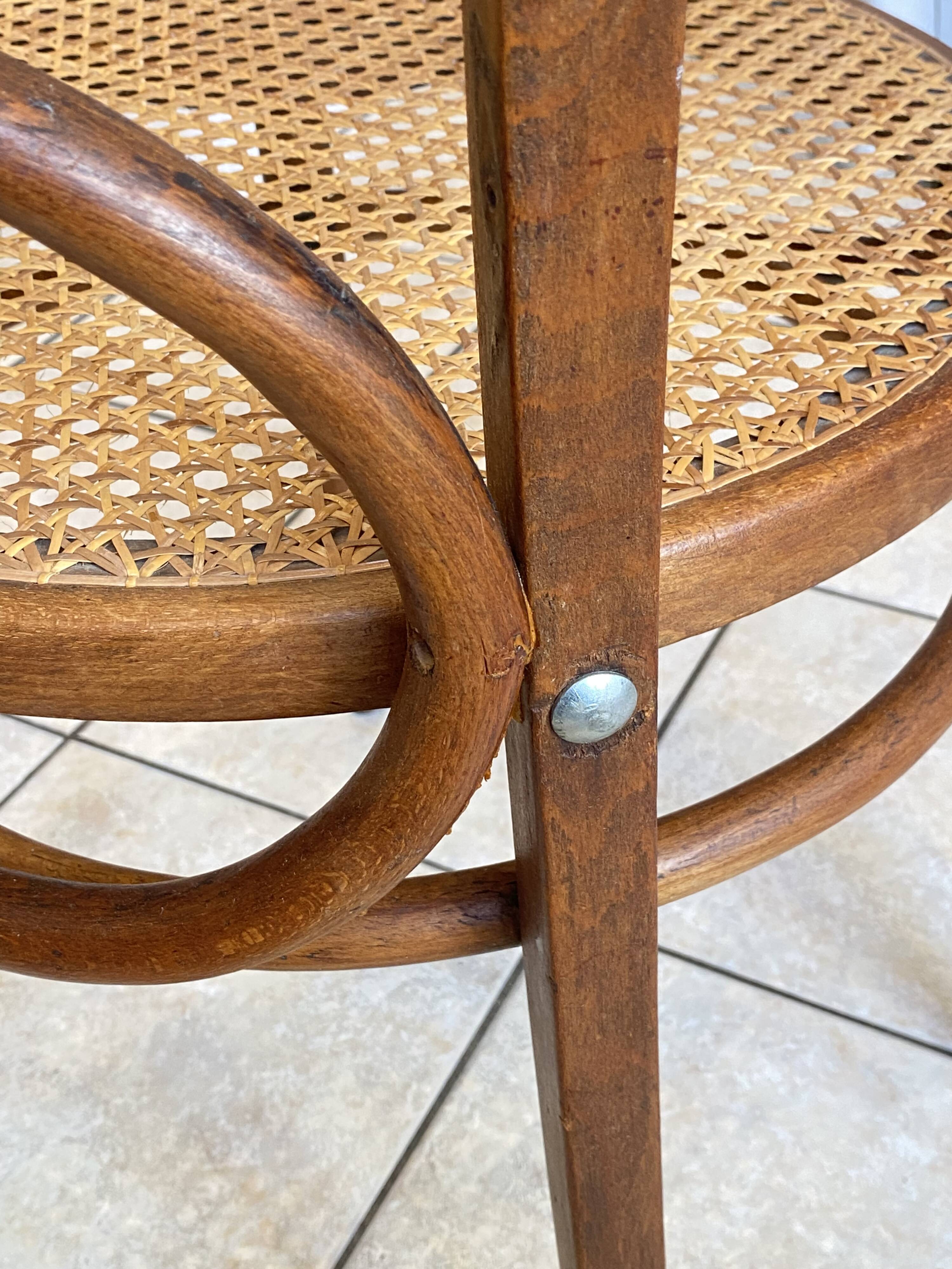 Bistro chair with a curved wooden frame and caned seat from the 1930s.