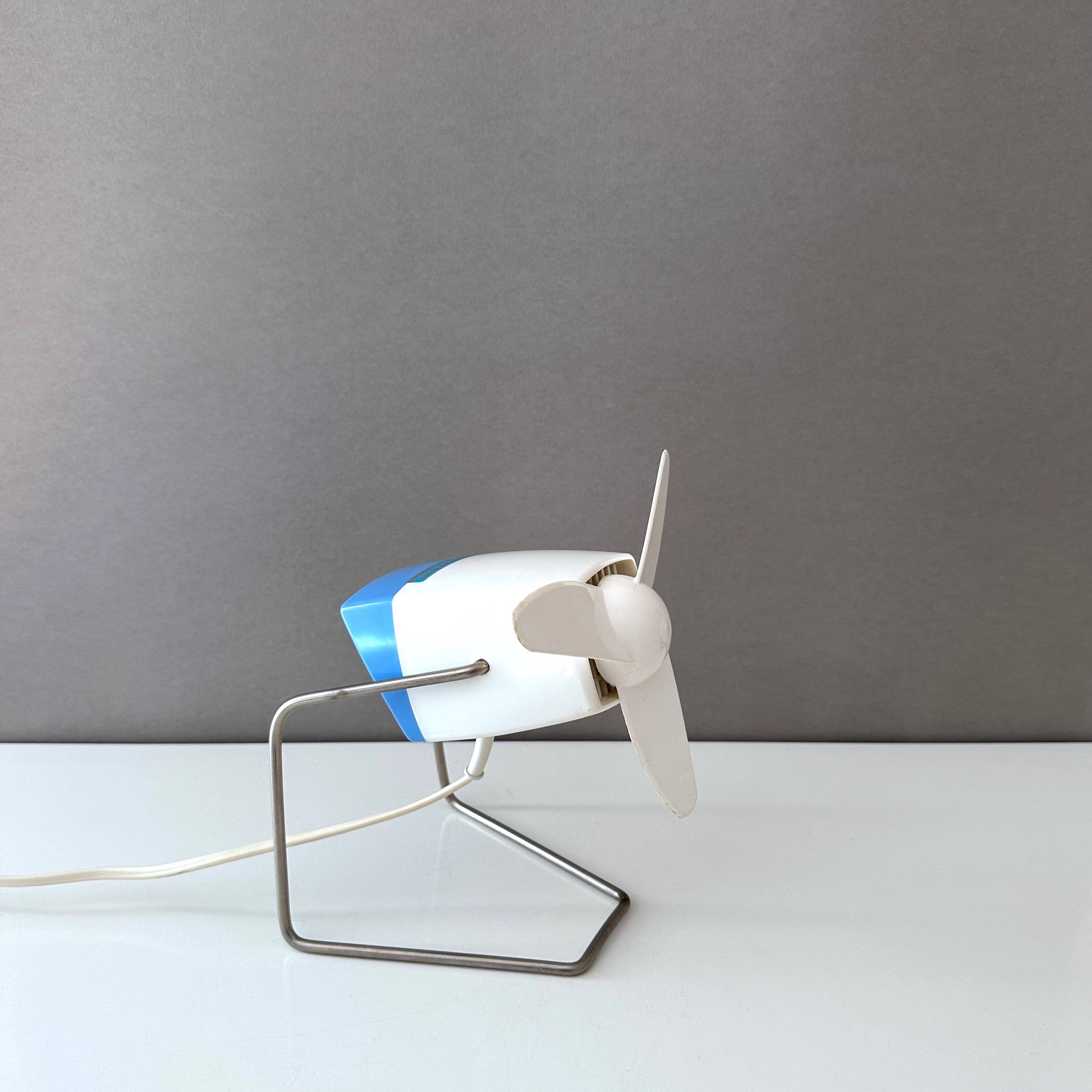 Blue Severin electric fan, mid-century office