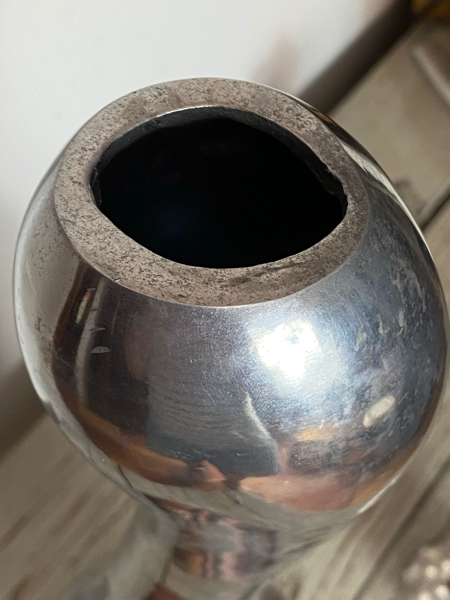 Large organic vase in polished aluminium cast.