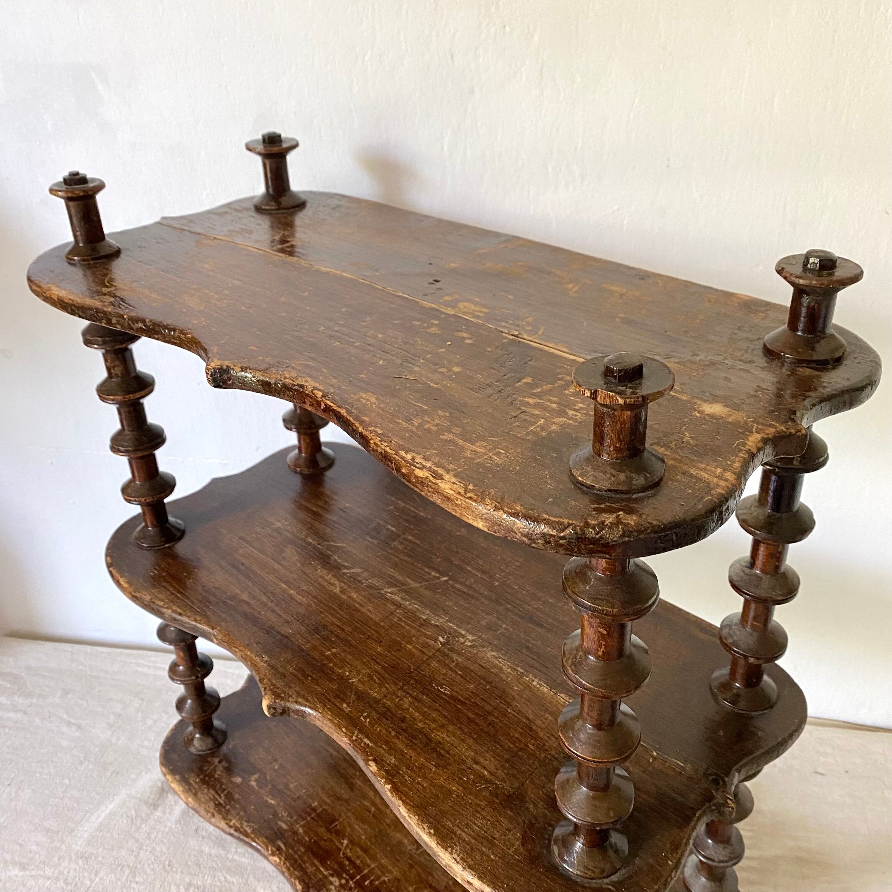 Old shelf in turned wood like reels