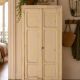 Small antique wardrobe patinated in beige and yellow.
