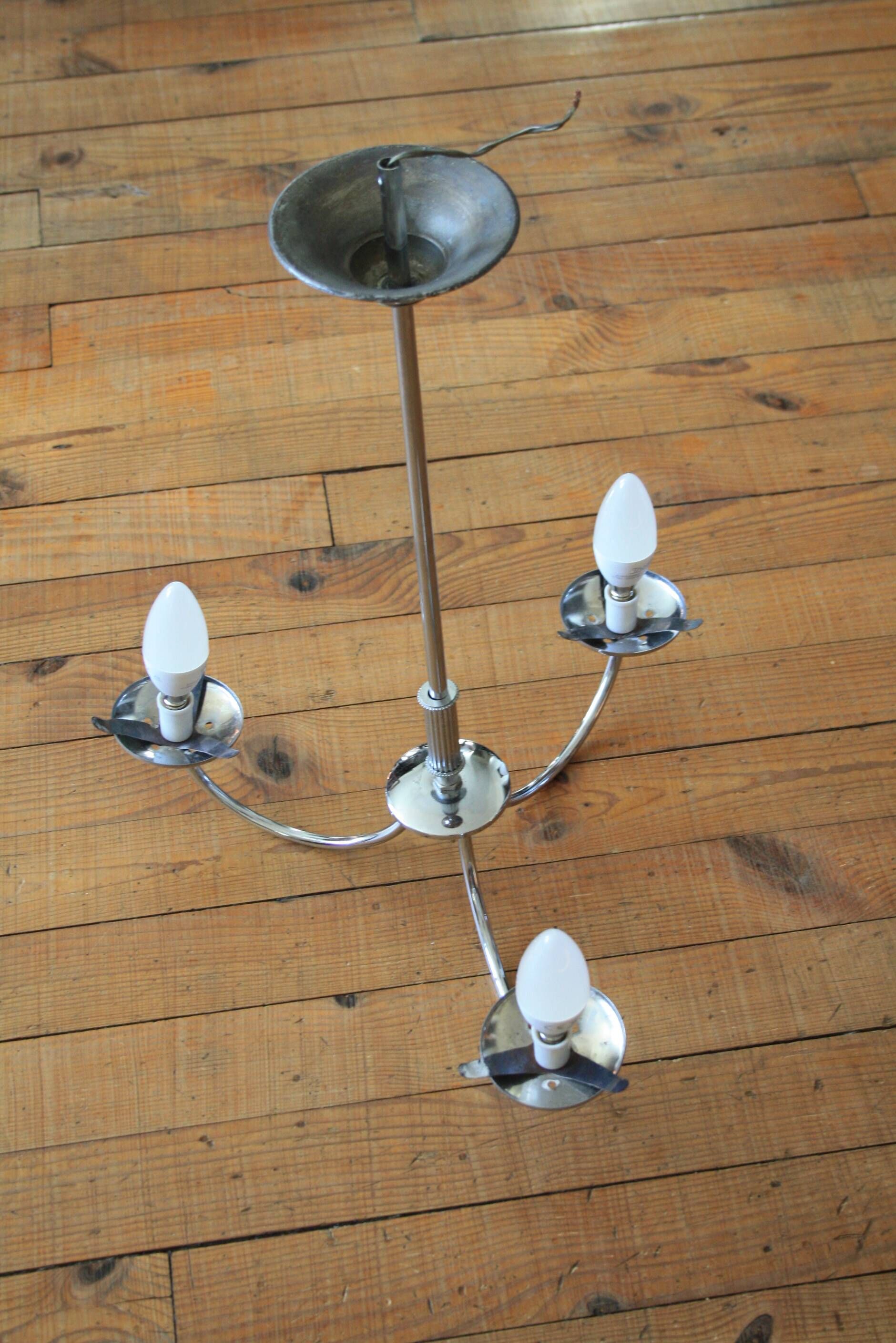 Chrome metal chandelier with smoked glass globes.