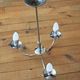 Chrome metal chandelier with smoked glass globes.