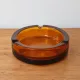 Vintage Italian round ashtray in thick amber glass – Ø 15 cm