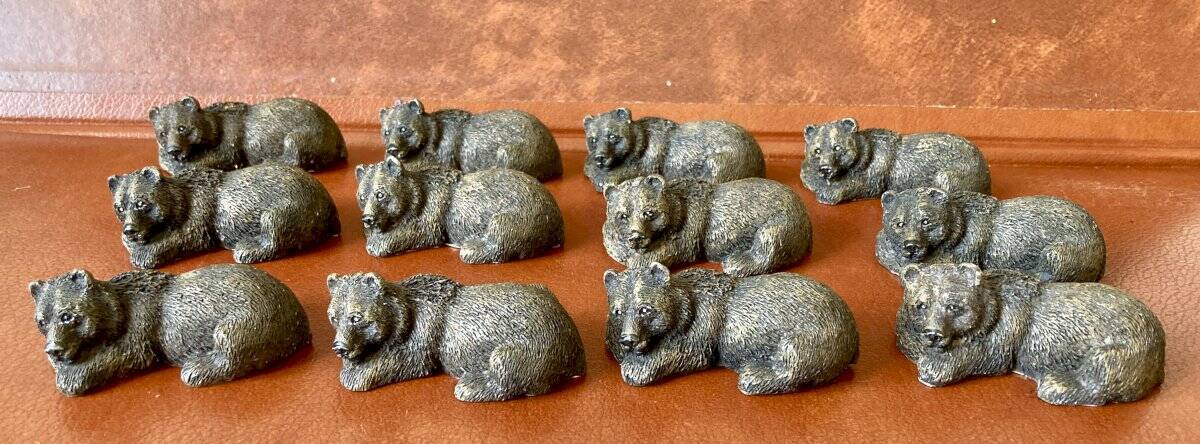 12 elongated brown bear-shaped knife rests