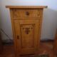 Vintage wooden bedside table painted brown, with a drawer and door, painted decoration from the 1890s.