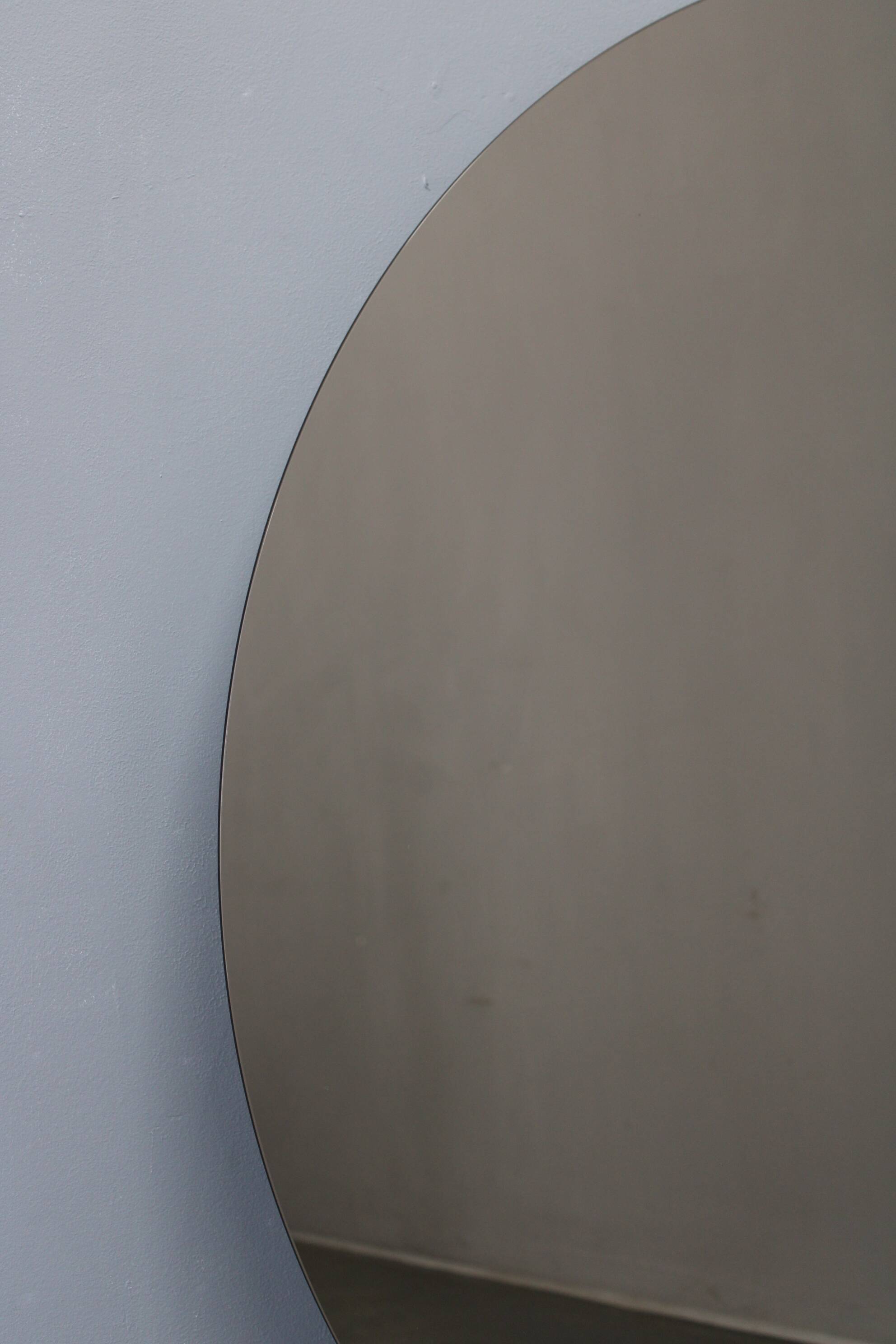 Large 1980s Italian smoke-tinted round mirror with white geometric segment