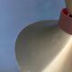 Large UFO flying saucer pendant light with orange light.