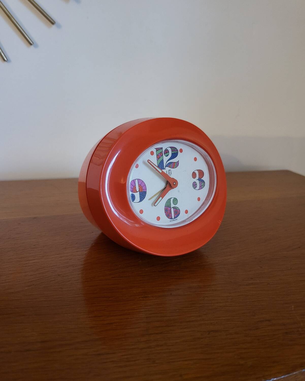 Vintage mechanical alarm clock in orange plastic Uti West Germany