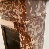 Red marble fireplace with modillion