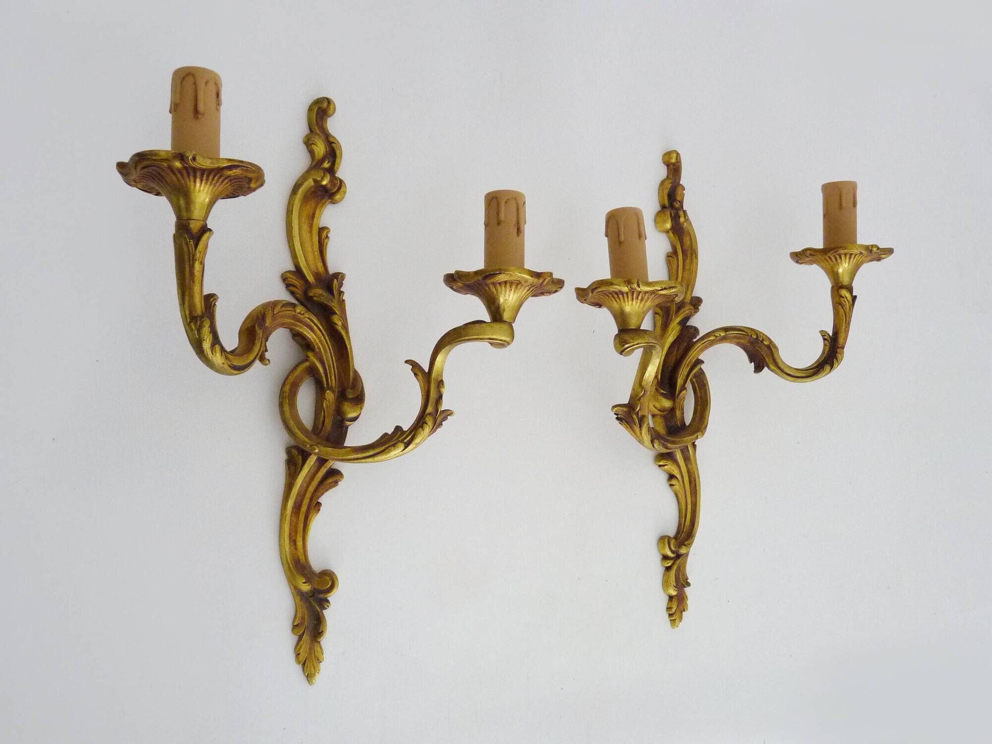 Antique pair of double-light bronze wall sconces with acanthus leaves. 1950s