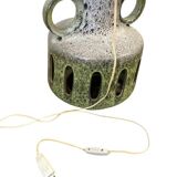 Vintage ceramic floor lamp with illuminated base.