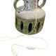 Vintage ceramic floor lamp with illuminated base.