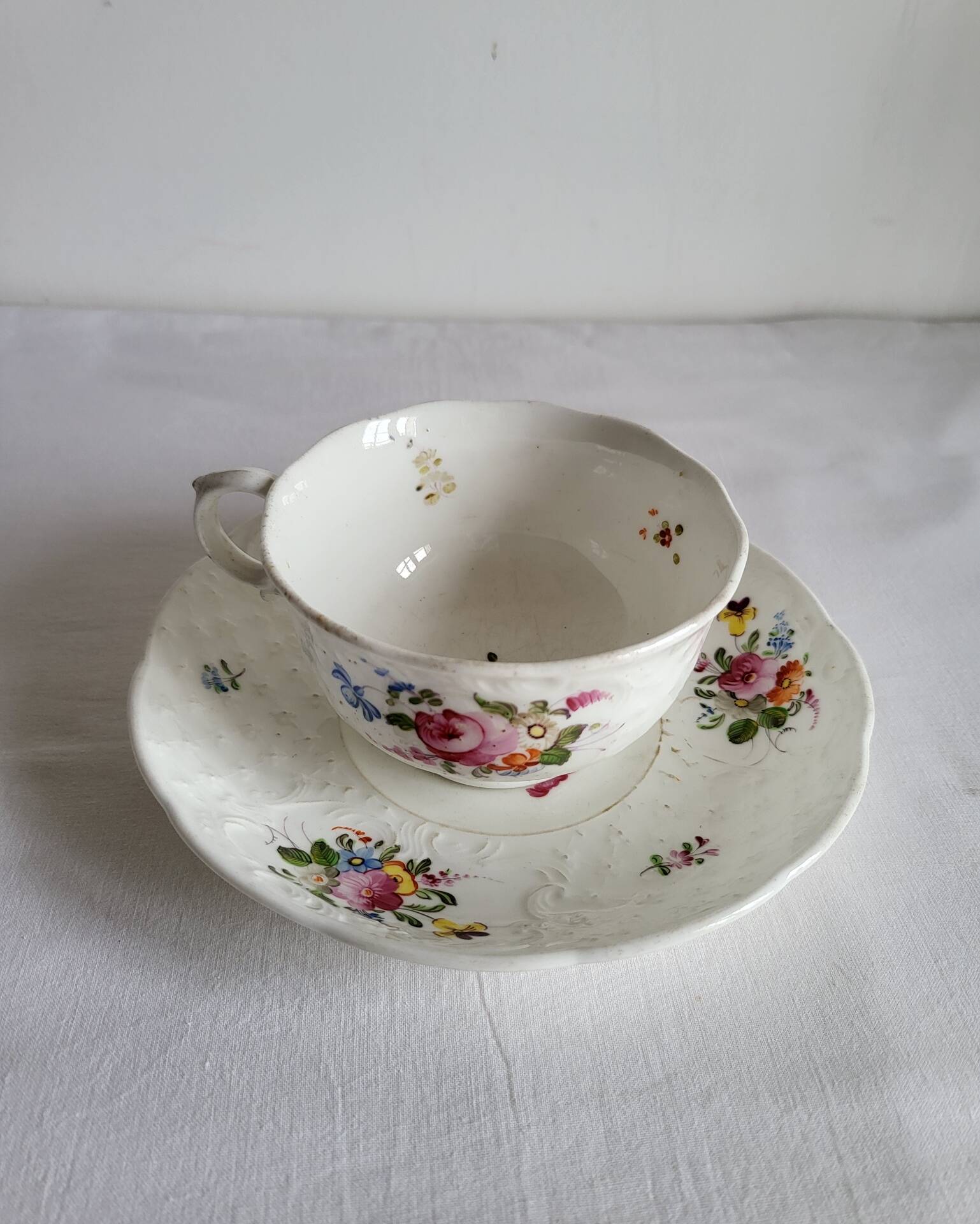 Antique Cup and Saucer in Porcelain with Hand-Painted Floral Decoration