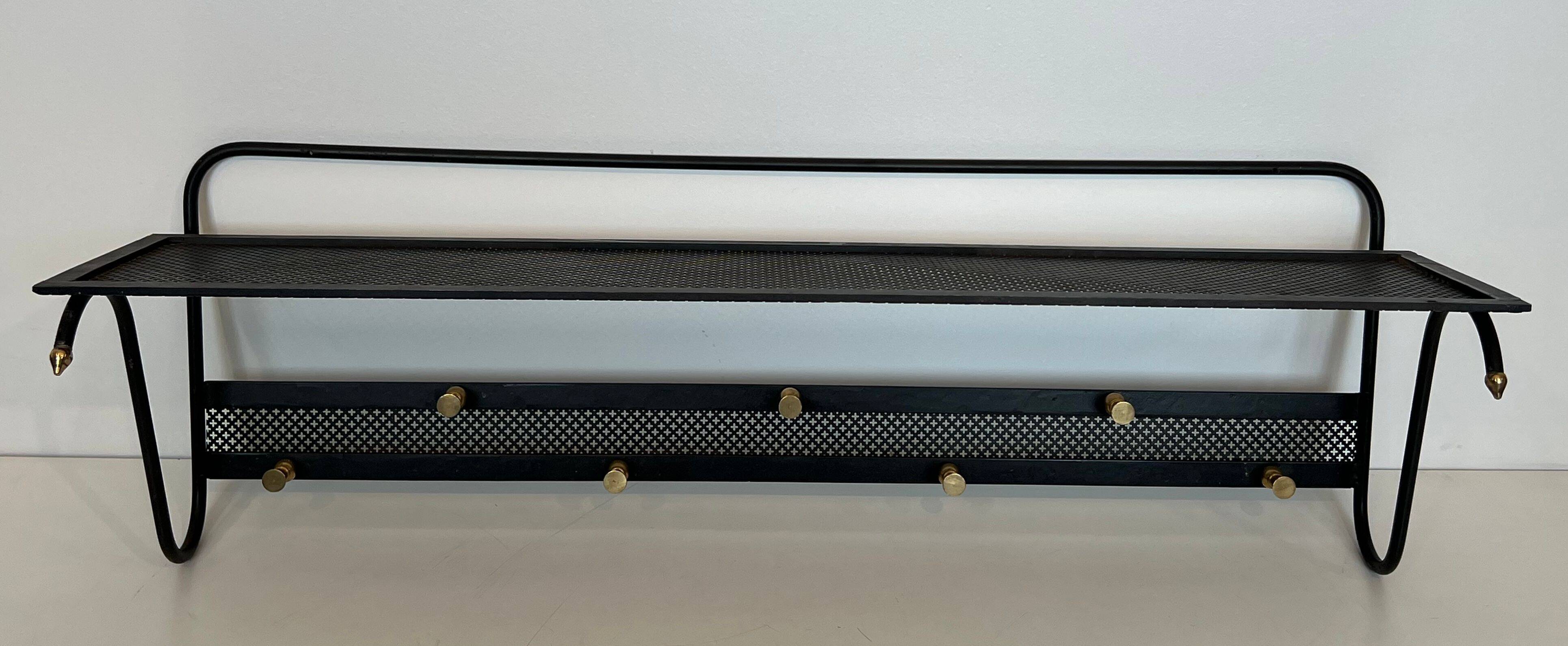 Coat rack in black lacquered metal, perforated sheet metal and brass in the style of Mathieu Matégot