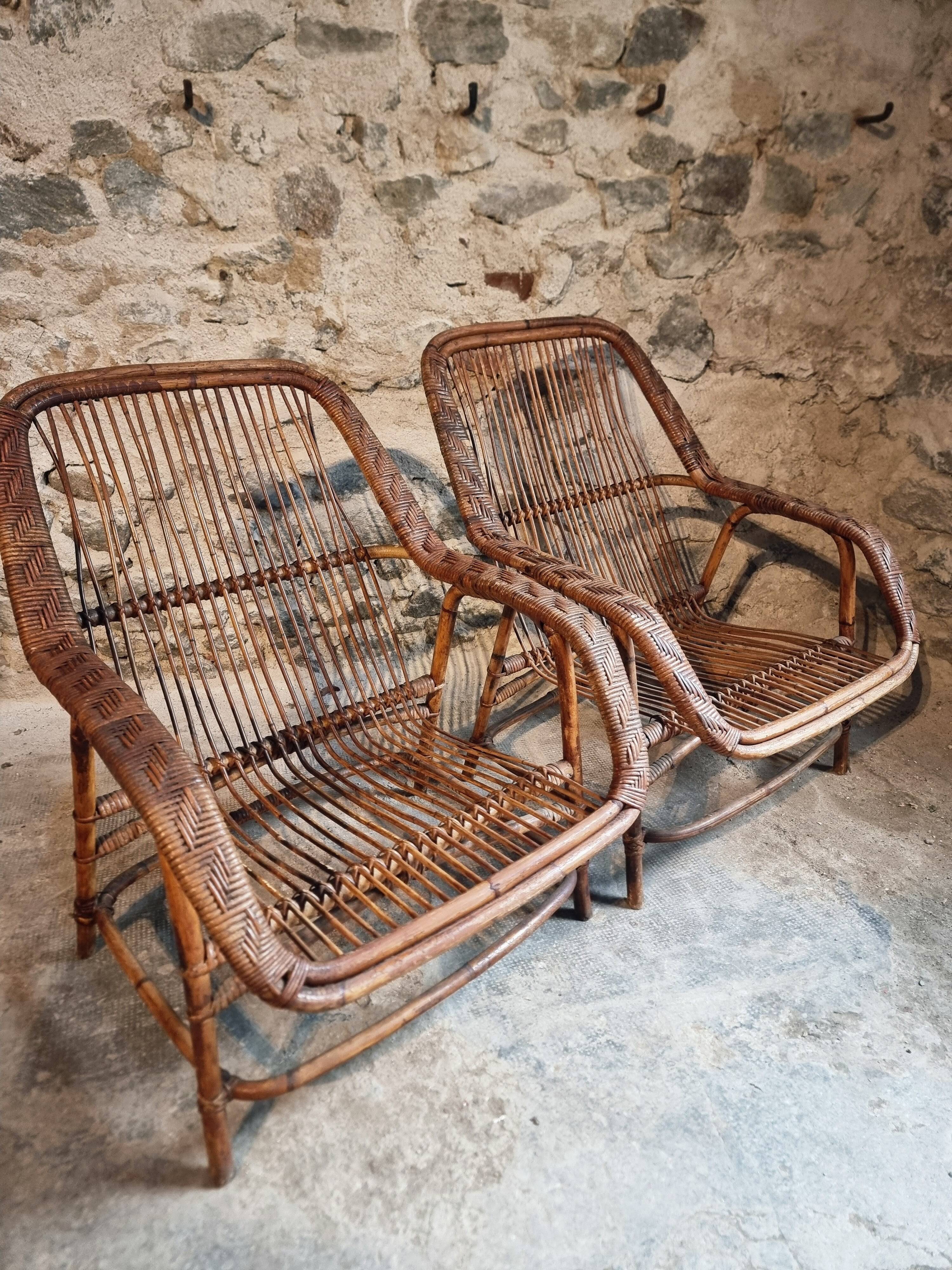 Vintage rattan lounge set, French wicker armchairs and round table, circa 1930–1950.