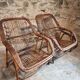Vintage rattan lounge set, French wicker armchairs and round table, circa 1930–1950.