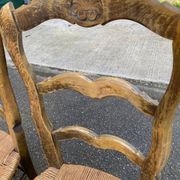 2 solid oak carved and rush-seated chairs in the Louis XV style from the 19th century.