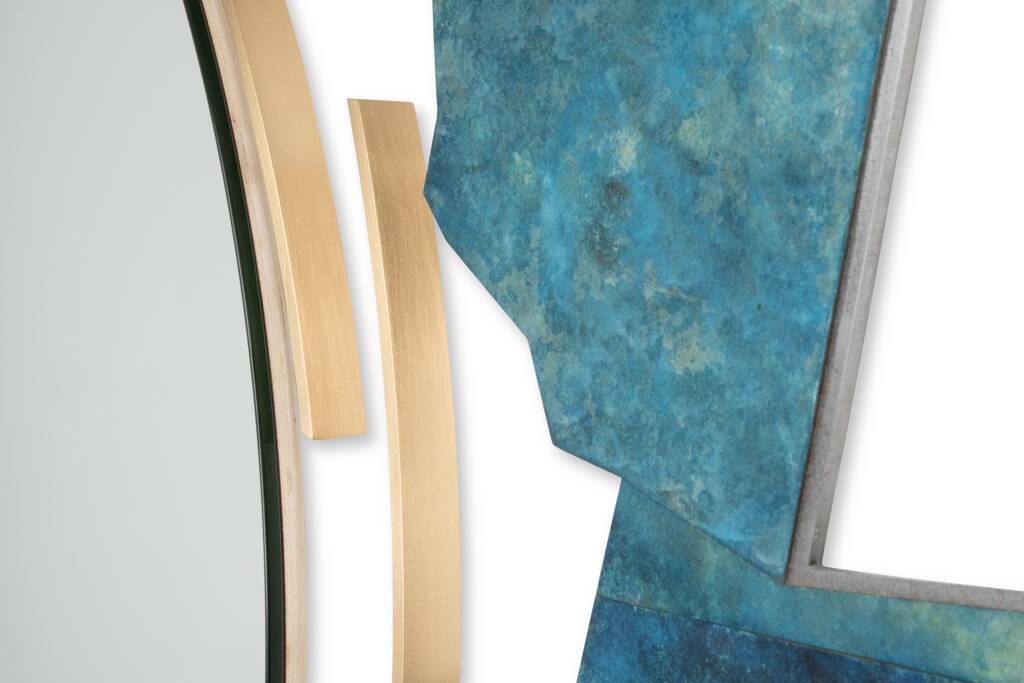Contemporary mirror in oxidized bronze and brass with a deconstructed shape.