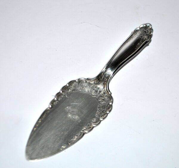 Vintage silver-plated pie server with rose decoration.