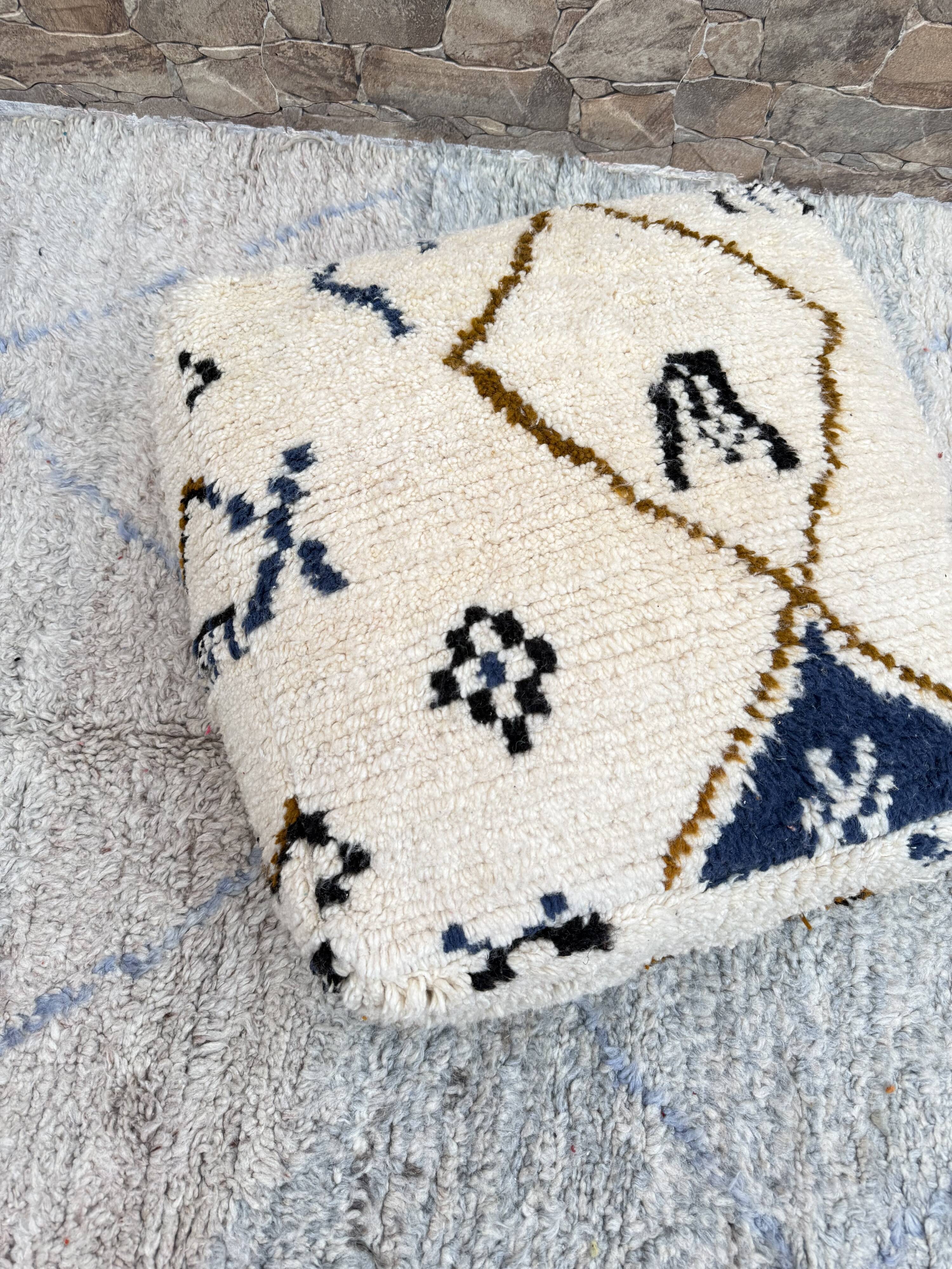 Berber floor pouf: Handwoven Moroccan wool cushion.