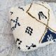 Berber floor pouf: Handwoven Moroccan wool cushion.