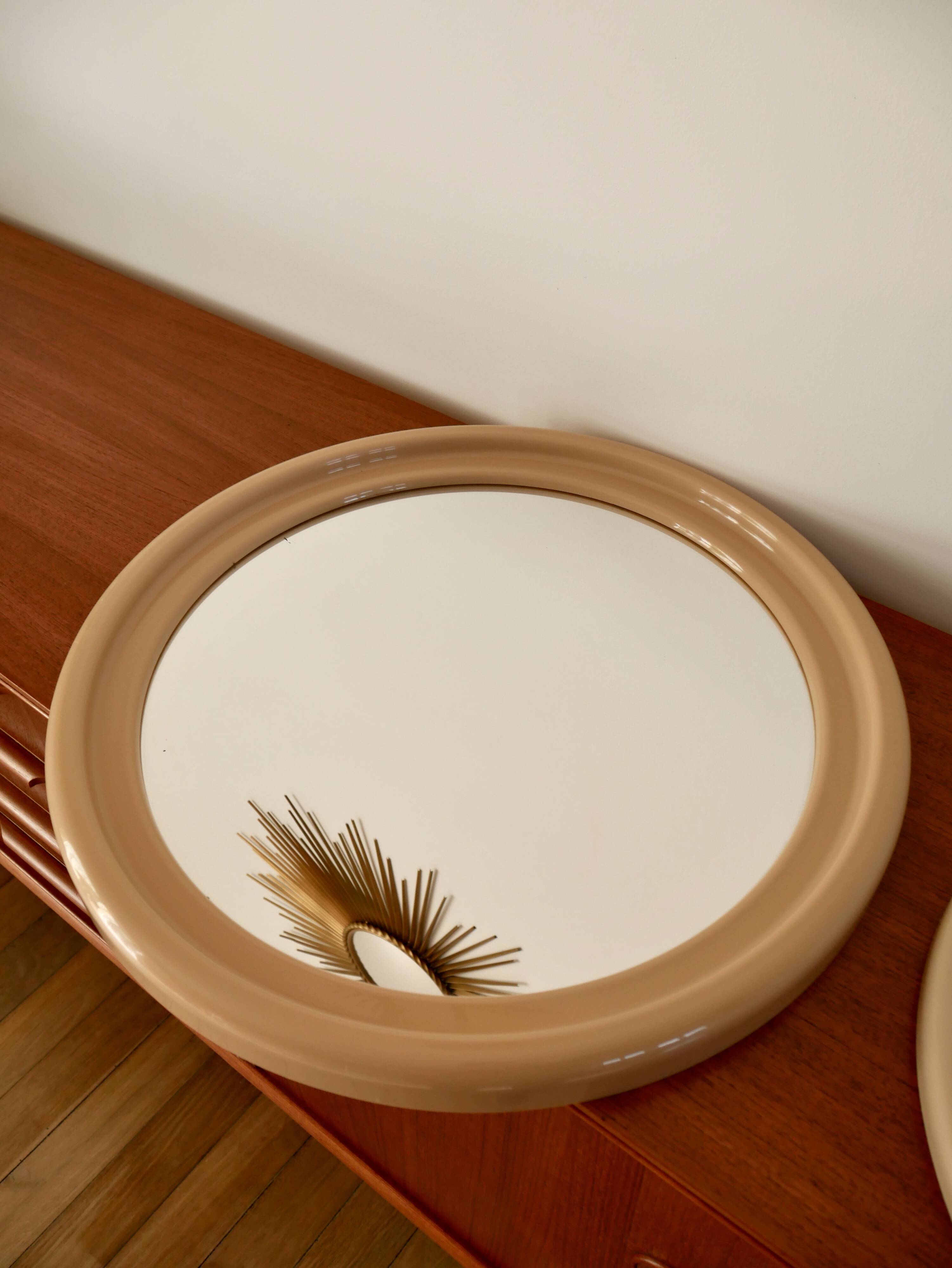 Large round mirror in pink beige plastic from the 70s