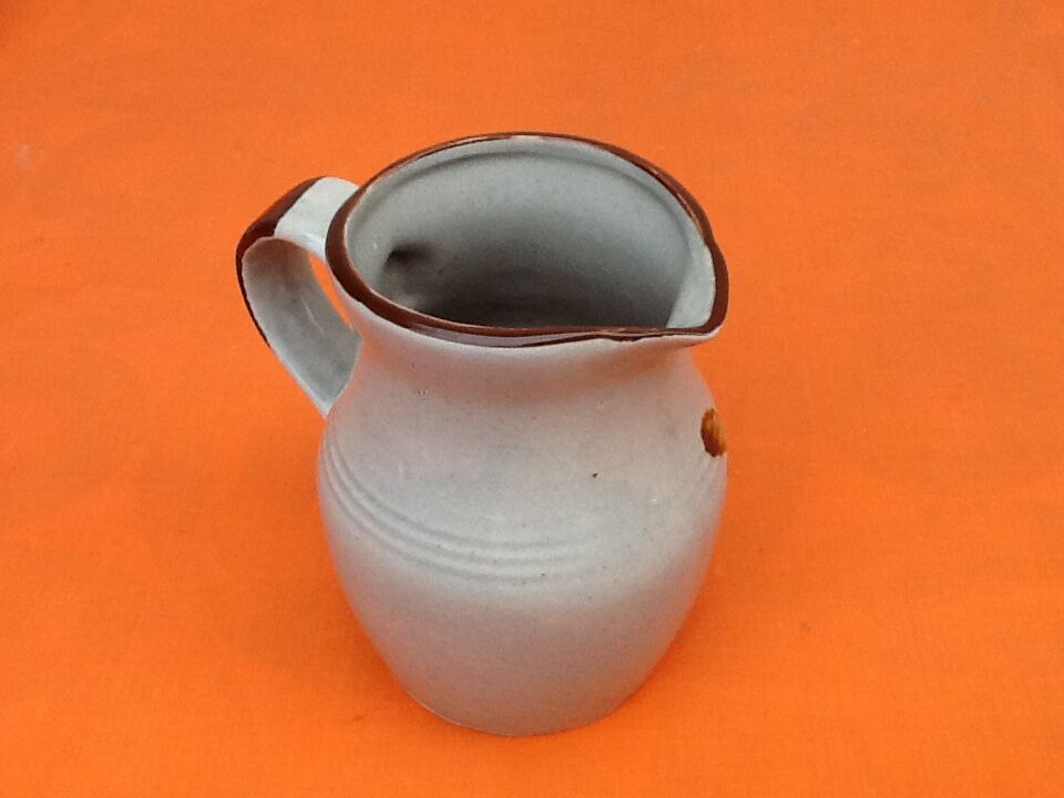 Glazed ceramic pitcher floral decoration