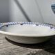 Round, shallow ceramic salad bowl from Saint Amand