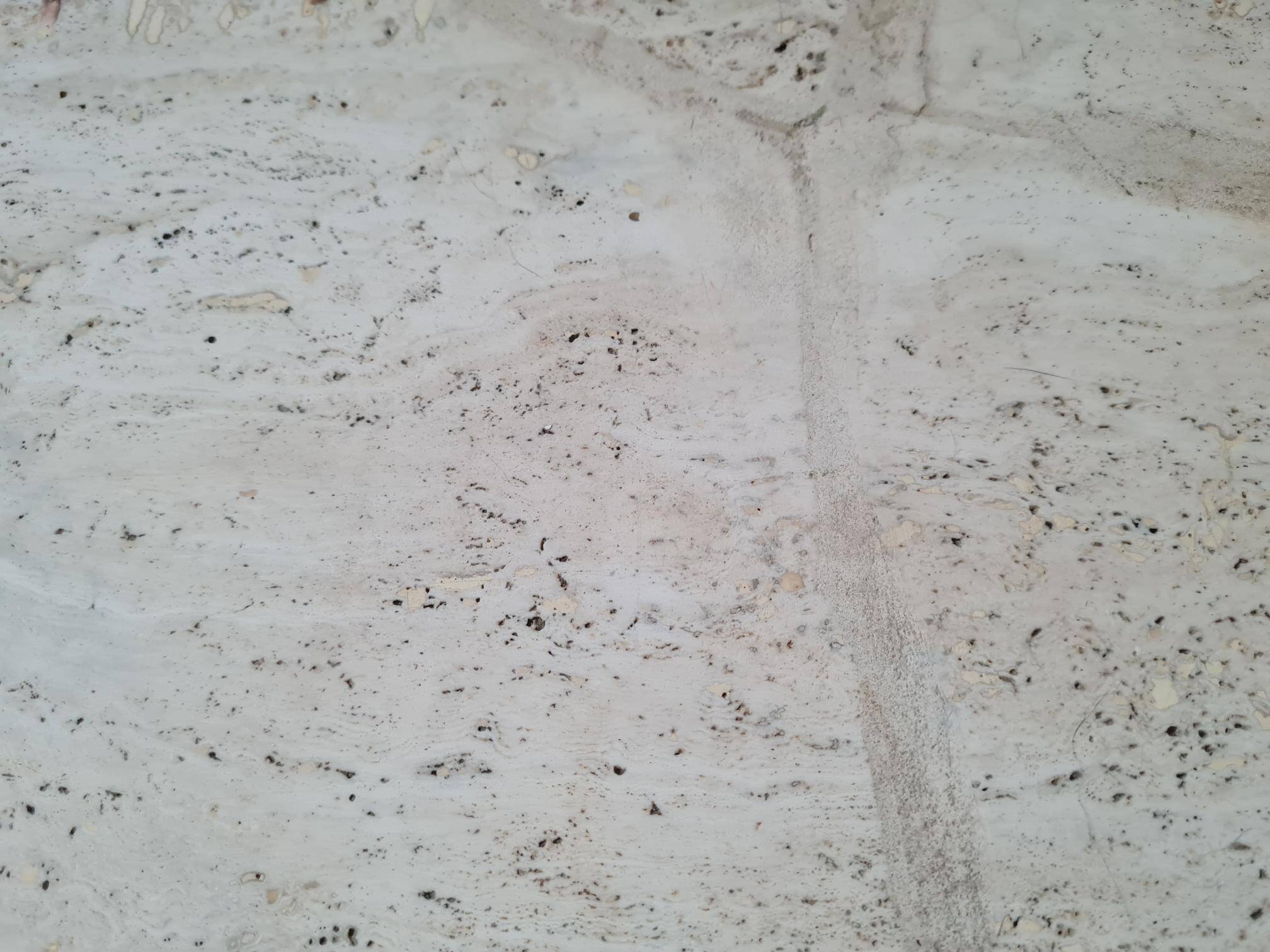 Pair of travertine nesting tables